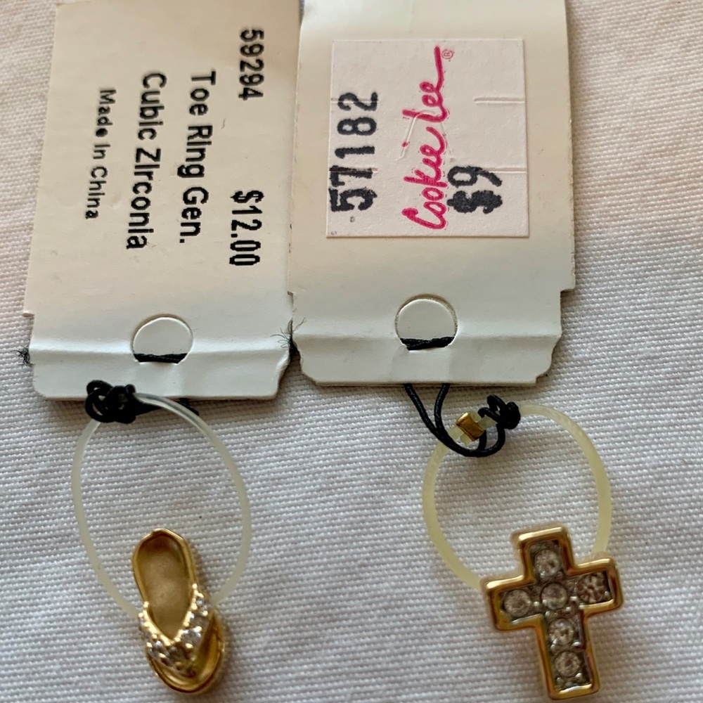 2 Cookie Lee toe rings. 1 flip-flop, 1 cross.